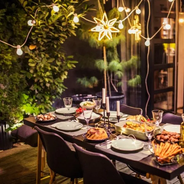Outdoor dinner table set with food and string lights at Hibachi Catering 4 U, a Chinese restaurant in Anselmo